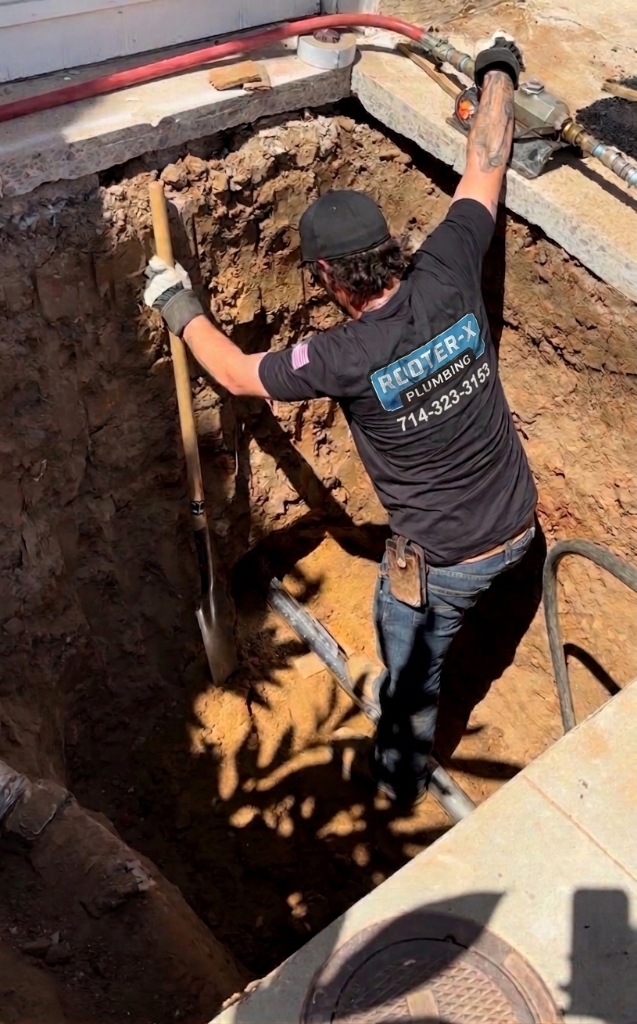 Rooter-X technician on main sewer line excavation job site