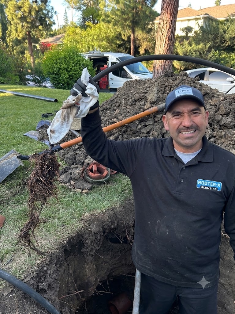 Rooter-X technician displaying camera-proven sewer root removal